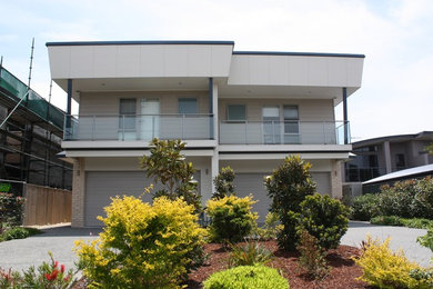 Design ideas for a contemporary two-storey white exterior in Newcastle - Maitland with concrete fiberboard siding.