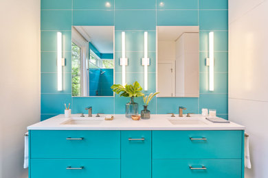 Mid-sized trendy master blue tile double-sink open shower photo in Austin with flat-panel cabinets, blue cabinets, blue walls, an undermount sink, white countertops and a floating vanity