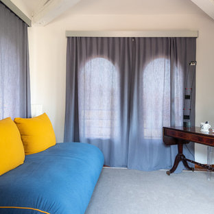 Small modern craft room in Florence with white walls, terracotta flooring, a freestanding desk and brown floors.