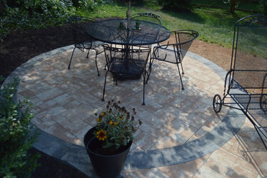 Inspiration for a backyard patio in DC Metro with brick pavers.