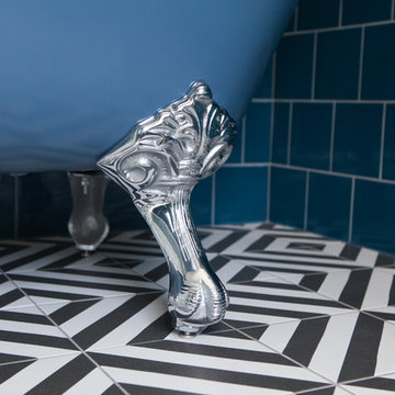 Blue-tiled main bathroom with slipper bath and geometric flooring - Hove