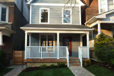 This is an example of a mid-sized beach style three-storey blue exterior in Toronto with wood siding.