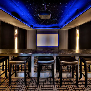 Contemporary enclosed home cinema in Kansas City with a projector screen, brown walls, carpet and multi-coloured floors.