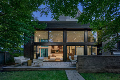 Inspiration for a huge modern backyard stone patio kitchen remodel in Chicago