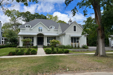 Inspiration for a mid-sized farmhouse beige two-story concrete fiberboard and clapboard exterior home remodel in Chicago with a shingle roof and a gray roof