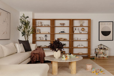 Danish light wood floor and beige floor living room photo in Boston with white walls