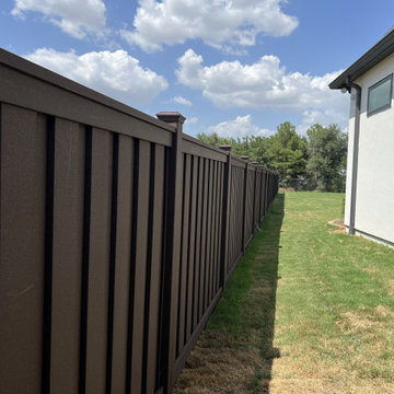 Dark Brown Composite Trex Fence and Black Iron Fence