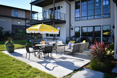 Patio - huge contemporary backyard concrete patio idea in Denver with a fire pit
