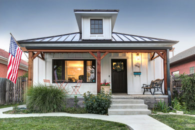 Inspiration for a mid-sized farmhouse white two-story wood exterior home remodel in Denver with a metal roof