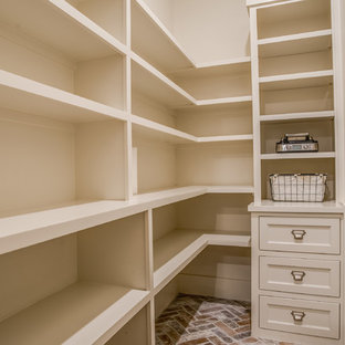 Design ideas for a transitional kitchen pantry in Austin with a farmhouse sink, shaker cabinets, quartzite benchtops, porcelain splashback, stainless steel appliances, brick floors and with island.