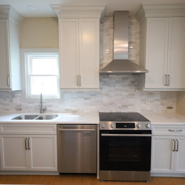 Sleek & Sophisticated: Gray Kitchen Remodel with Quartz Countertops, Marble Back