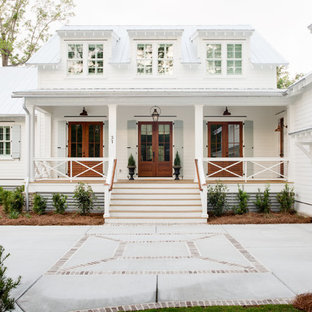 Inspiration for a country two-storey white house exterior in Charleston with wood siding and a metal roof.