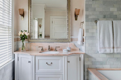 Inspiration for a large timeless master gray tile and marble tile marble floor, multicolored floor and single-sink bathroom remodel with furniture-like cabinets, white cabinets, an undermount tub, a two-piece toilet, multicolored walls, an undermount sink, marble countertops, multicolored countertops, a niche and a freestanding vanity