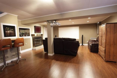 Example of a transitional medium tone wood floor basement design in Calgary with beige walls and a standard fireplace