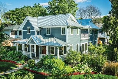 Example of a two-story exterior home design in Chicago with a hip roof
