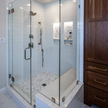 Luxury Spa Bathroom with Natural Warm Vanities, Quartz Countertop, Tiled Shower