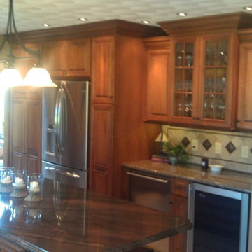 Omega Cabinetry. Destin door, Cherry wood, Nutmeg stain.