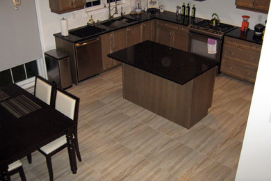 Eat-in kitchen - mid-sized transitional l-shaped ceramic tile eat-in kitchen idea in Toronto with a double-bowl sink, raised-panel cabinets, medium tone wood cabinets, quartzite countertops and an island
