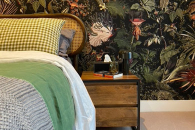 Inspiration for a medium sized modern guest and cream and black bedroom in London with multi-coloured walls, carpet, beige floors, wallpapered walls and a feature wall.
