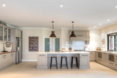 Photo of a large eat-in kitchen in Sydney with shaker cabinets, quartz benchtops, white splashback, ceramic splashback, stainless steel appliances and with island.