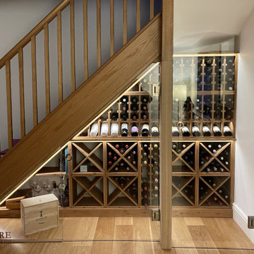 Bespoke under stairs wine storage with a glass front in Leicestershire