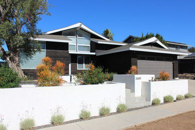 Inspiration for a mid-sized asian black two-story wood house exterior remodel in San Diego with a shingle roof