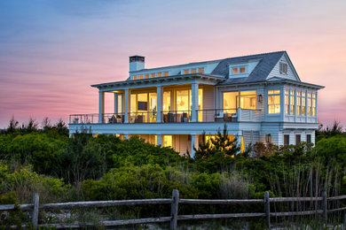 Inspiration for a coastal white two-story clapboard house exterior remodel in Philadelphia with a shingle roof