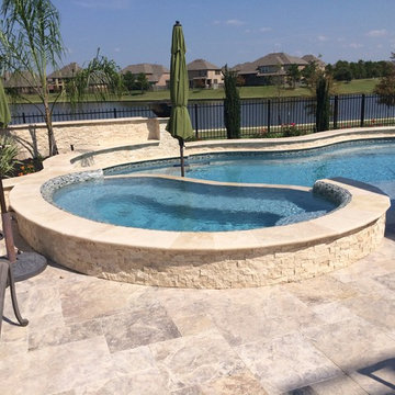 Travertine Freeform Pool with a view in Cypress