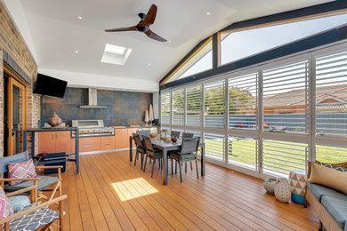 Inspiration for a mid-sized contemporary sunroom in Sydney with dark hardwood floors, a skylight and brown floor.