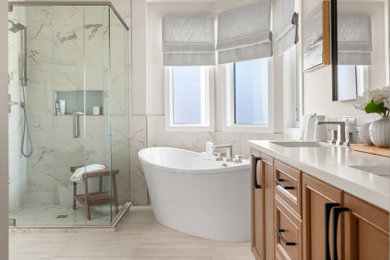 Example of a beach style blue tile double-sink bathroom design in Calgary with shaker cabinets, medium tone wood cabinets, a hinged shower door and a freestanding vanity