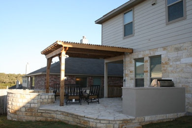 Large elegant backyard deck photo in Austin with a pergola
