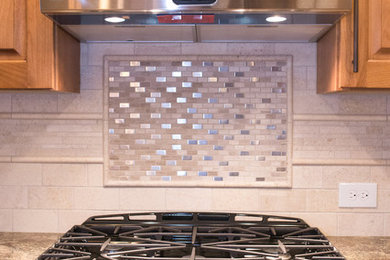 Open concept kitchen - mid-sized traditional galley light wood floor open concept kitchen idea in Denver with an undermount sink, louvered cabinets, light wood cabinets, granite countertops, stone tile backsplash, stainless steel appliances and an island