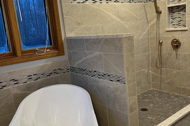 Large transitional master gray tile and porcelain tile porcelain tile and gray floor bathroom photo in Other with gray walls