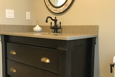 Inspiration for a small traditional 3/4 bathroom in Bridgeport with furniture-like cabinets, dark wood cabinets, a one-piece toilet, beige walls, porcelain floors, an undermount sink, granite benchtops and beige floor.