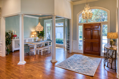 Inspiration for a coastal medium tone wood floor, tray ceiling and wallpaper entryway remodel in Atlanta