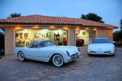 Example of a large tuscan three-car garage design in Tampa