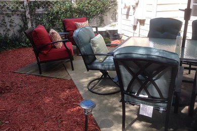 Inspiration for a small transitional backyard concrete patio remodel in Other with no cover