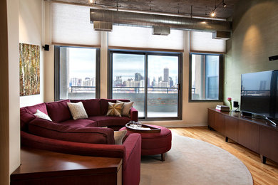 Living room - large contemporary open concept medium tone wood floor living room idea in Chicago with beige walls, no fireplace and a tv stand