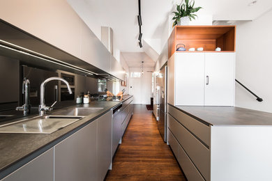 Contemporary galley eat-in kitchen in Sydney with a double-bowl sink, grey cabinets and a peninsula.