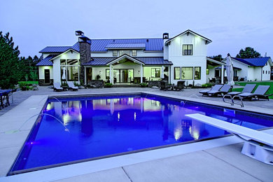 Example of a huge cottage two-story wood exterior home design in Denver with a metal roof