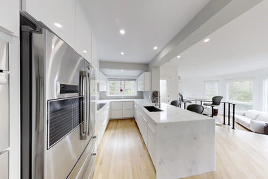 This is an example of a modern kitchen in DC Metro with beige floor.