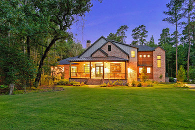Inspiration for a large cottage red two-story brick exterior home remodel in Houston with a shingle roof