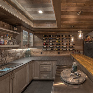 This is an example of a large rustic fully buried basement in Other with brown walls, carpet, a hanging fireplace, a tiled fireplace surround and beige floors.