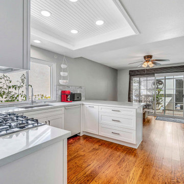 Modern White Kitchen Remodel with Quartz Countertops & Peninsula