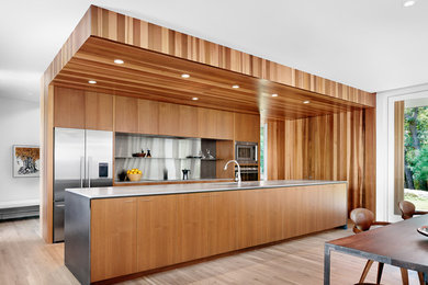 Large trendy galley open concept kitchen photo in Austin with flat-panel cabinets, medium tone wood cabinets and an island