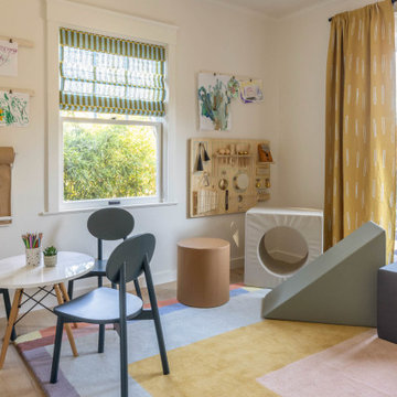 Kids’ Playroom with French Doors, Colorful Rug, and Activity Wall