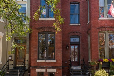 Inspiration for a small traditional two-storey brick red townhouse exterior in DC Metro with a flat roof.