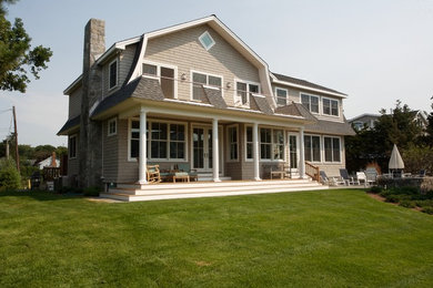 Beach style two-story wood exterior home photo in New York with a gambrel roof