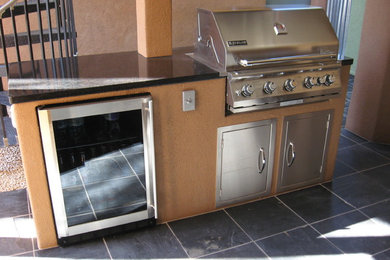 Example of a mid-sized classic backyard tile patio kitchen design in Phoenix with a roof extension
