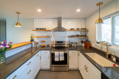 Inspiration for a mid-sized contemporary u-shaped porcelain tile and gray floor eat-in kitchen remodel in Denver with an undermount sink, shaker cabinets, white cabinets, quartz countertops, white backsplash, subway tile backsplash, stainless steel appliances and gray countertops